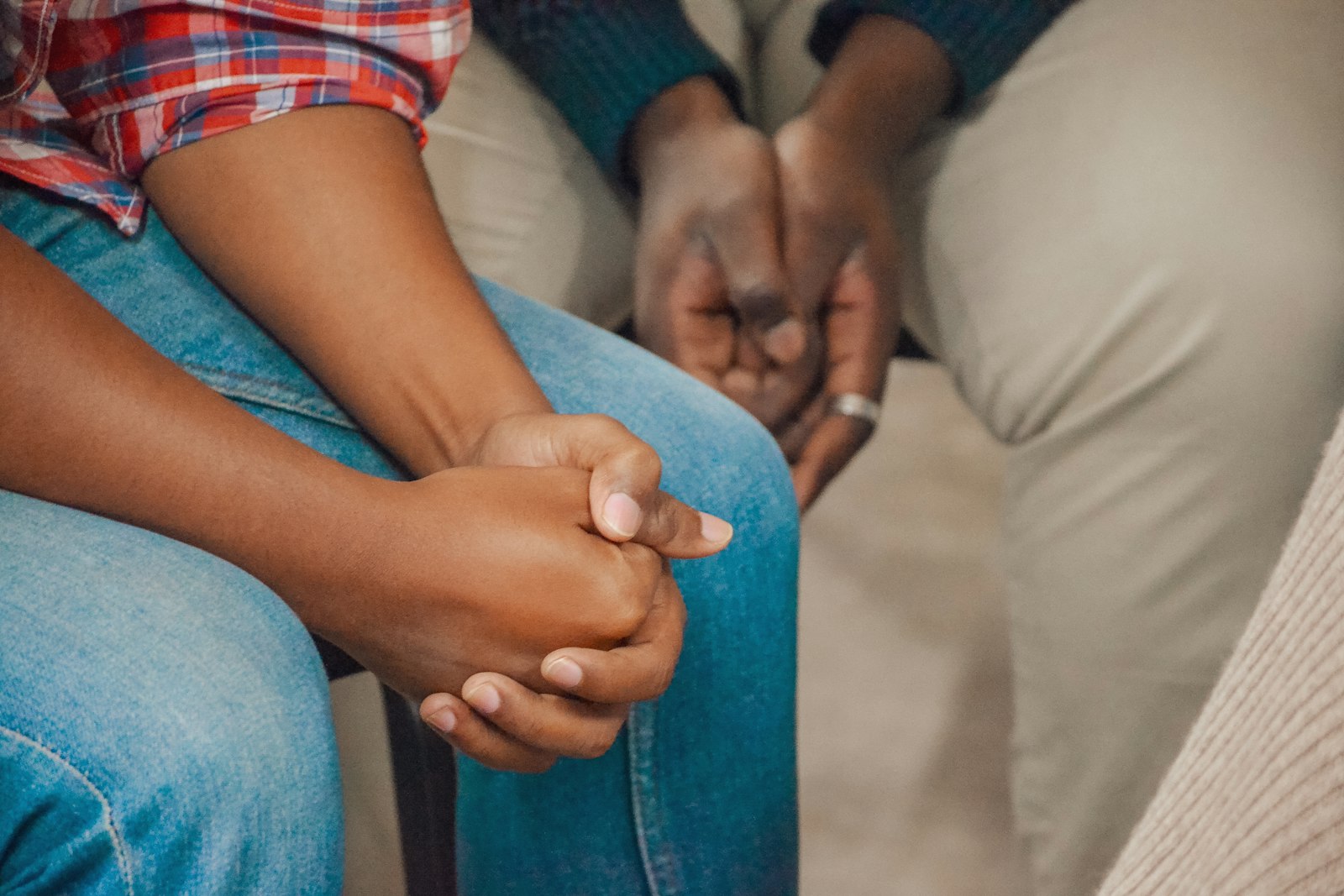 Two people holding hands in prayer