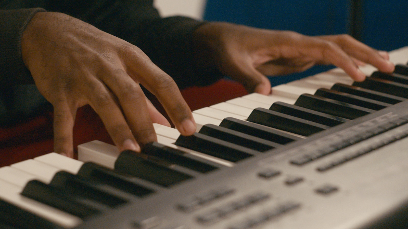 Hands playing a piano