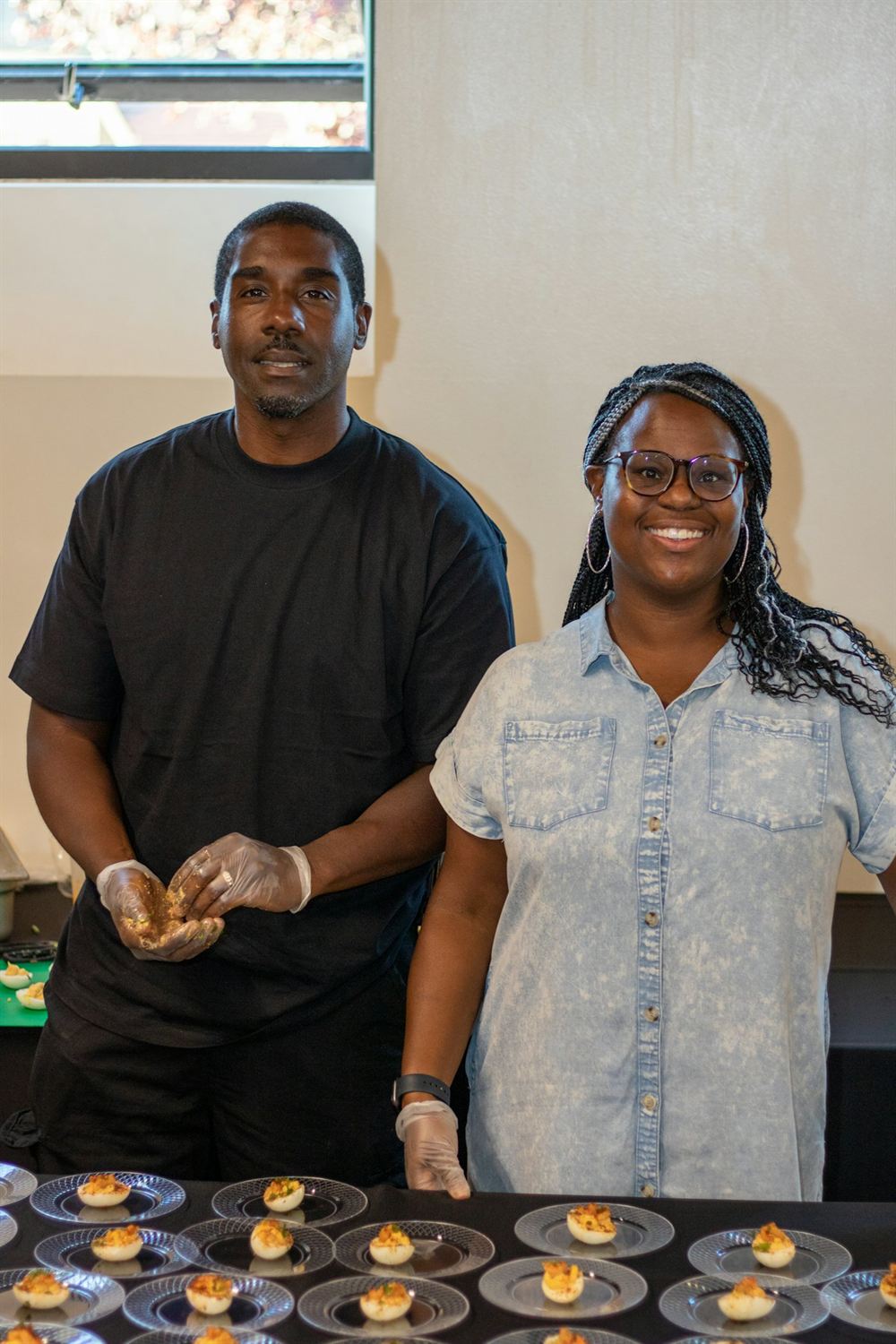 Two volunteers serving at a community meal